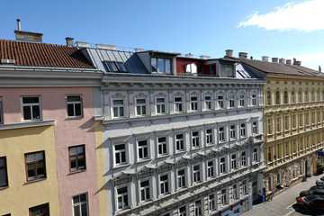 SIde view from opened window to the opposite house on bright sunny day