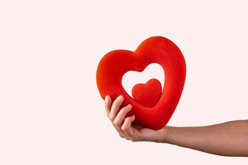 woman holds in her hands a red heart on a white background, concept valentines day