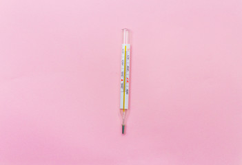  mercury thermometer on a pink background