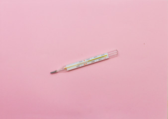  mercury thermometer on a pink background