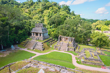 Fototapeta na wymiar Ancient Mayan ruins in Palenque, Chiapas, Mexico. Mayan ruins in the middle of the jungle on a sunny day.