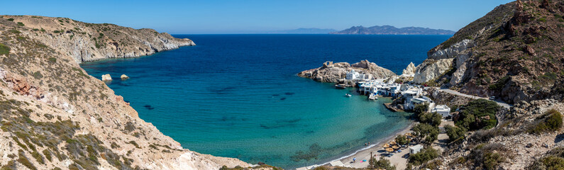 Panorama of Firopotamos beach with church, houses and cliffs