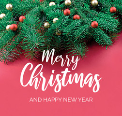 Merry Christmas and Happy New Year Sign with spruce branch. Christmas red background with ornate spruce branch stock images. Elegant holiday background. Red Christmas greeting card