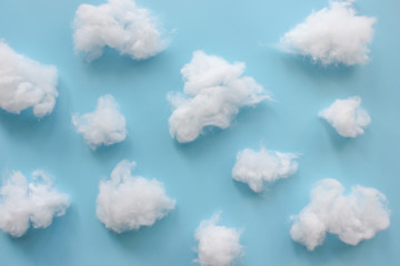 Cotton wool clouds on light blue background. - obrazy, fototapety, plakaty
