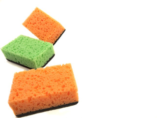 Kitchen washcloths isolated on white background. Composition of orange and green sponges. Washcloths for cleaning.