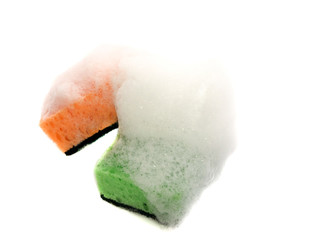 Kitchen sponges with foam isolated on a white background. Green and orange sponge in the foam. Kitchen washcloth for cleaning.