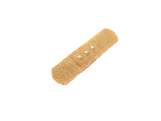 Medical plaster isolated on a white background. Brown medical plaster for first aid.