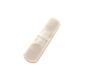 Medical plaster isolated on a white background. Brown medical plaster for first aid.