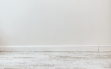 Empty room with white cement wall texture and white wooden floor pattern. 