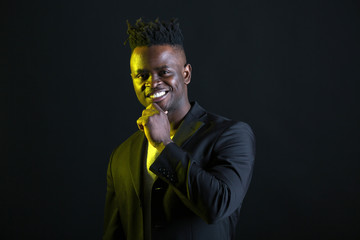 handsome african man in suit on black background