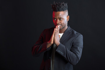 handsome african man in suit on black background