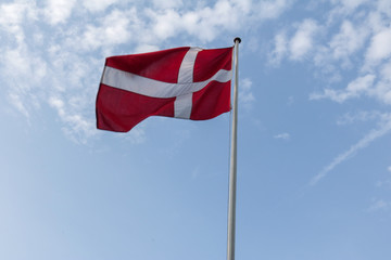 Danish flag waving against a blue sky