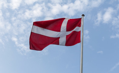 Danish flag waving against a blue sky