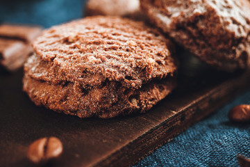 Homemade bakery, chocolate cookies with powdered sugar on blue napkin, close-up view