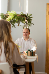 Happy husband and wife at the New Year's table.