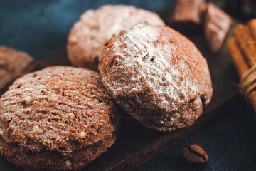 Homemade bakery, chocolate cookies with powdered sugar, close-up view