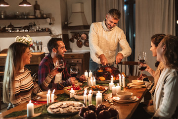 Fototapeta na wymiar Photo of charming excited people having Christmas dinner with turkey