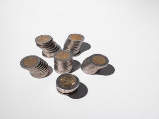 Curious background of six columns built by two euro coins on white background
