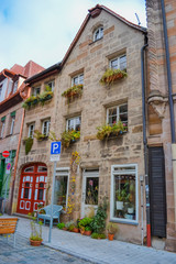 Fototapeta premium Furth, Germany, 21 November 2019: view of one of the city streets. 19th century houses with multi-colored facades. Bicycle parking. Garbage bins.