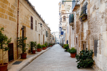 View of the old city, a street with doors and balconies. Road that leads forward