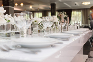 long served feast table with glases. festive table on the birthday or wedding party in the restaurant. Interior of the banquet hall in the cafe. banquet table in the restaurant. place of celebration