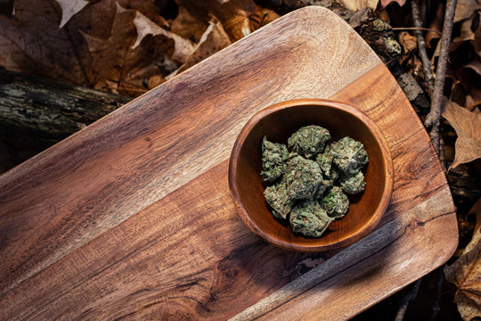 Close up on a wooden bowl filled with cannabis