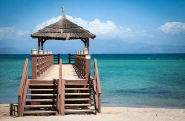Tropical beach with wooden footbridge and summer holiday background