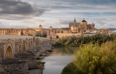Fototapeta premium Roman Bridge and Guadalquivir river at the sunset, Great Mosque, Cordoba, Spain