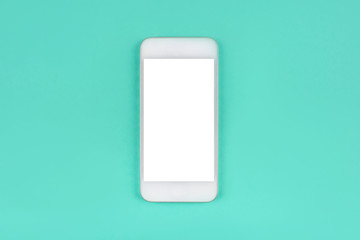 White smartphone on mint background.