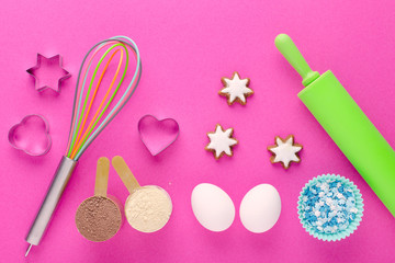 baking protein, eggs and kitchen tools with cookie cutter on pink background