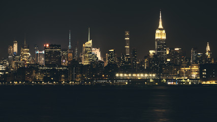 Fototapeta na wymiar New York City panorama at night, color toning applied, USA.