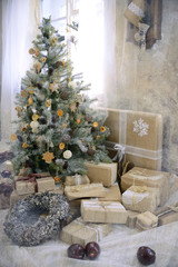 Beautiful decorated room with Christmas tree with presents under it.Rustic style