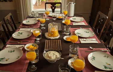 Brunch party dinning table with orange juice