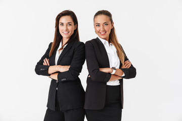 Photo of businesswomen smiling and posing with arms crossed