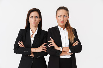 Photo of displeased businesswomen looking at camera with arms crossed