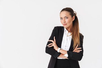Photo of young businesswoman looking at camera with arms crossed