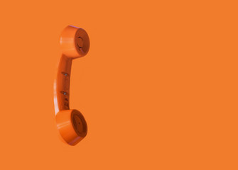Orange vintage telephone handset, retro style