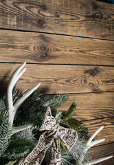 Fototapeta na wymiar Christmas wreath on wooden background whith deer horns