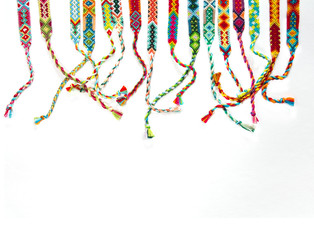 handmade friendship bracelets on white background, ethno boho style