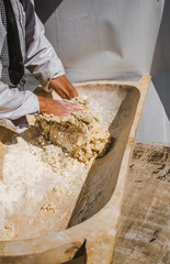 a man kneading dough for bread
