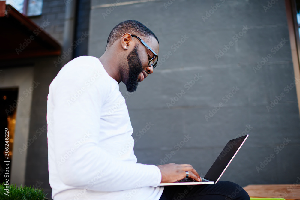 Poster side view of skilled male freelancer working remotely with startup project using 4g wireless connect