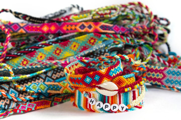 handmade friendship bracelets on white background, ethno boho style