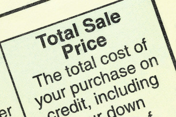 Close up macro view of total sale price detail in the standard federal truth in lending section on an automobile purchase loan form.