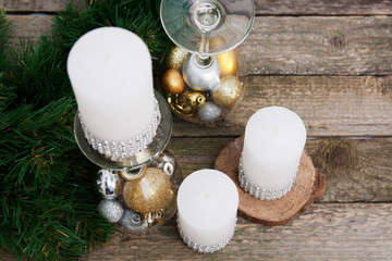 Christmas decor - candles, candlestick with Christmas tree toys on wooden table. Preparing for the Christmas holiday