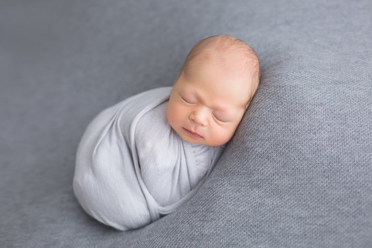 first photo shoot. newborn child. the child is lying on a gray blanket