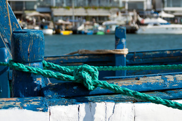 Nautical knotted rope on wooden boat 