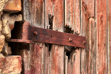 Rusty hinge on an old wooden door