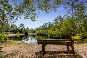 Fototapeta na wymiar Bench overlooking a peaceful lake