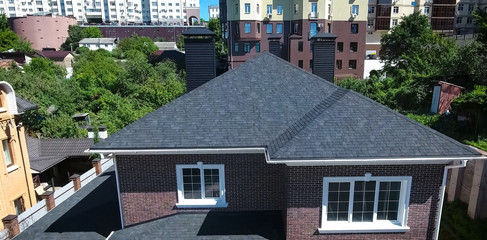 Bituminous tile for a roof. House with a roof from a bituminous tile. a roof from a bituminous tile. Moder