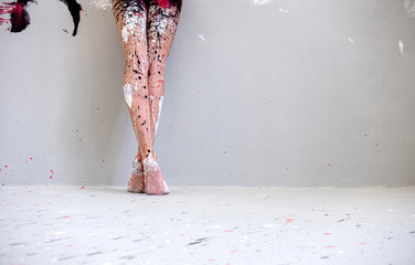 beautiful legs and feet of a young artistically abstract painted woman, ballerina with white, black...